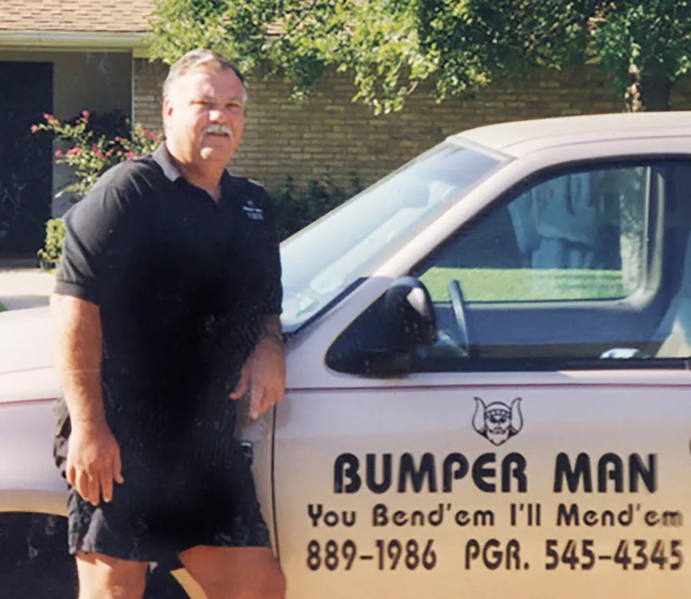 a man standing next to a white truck