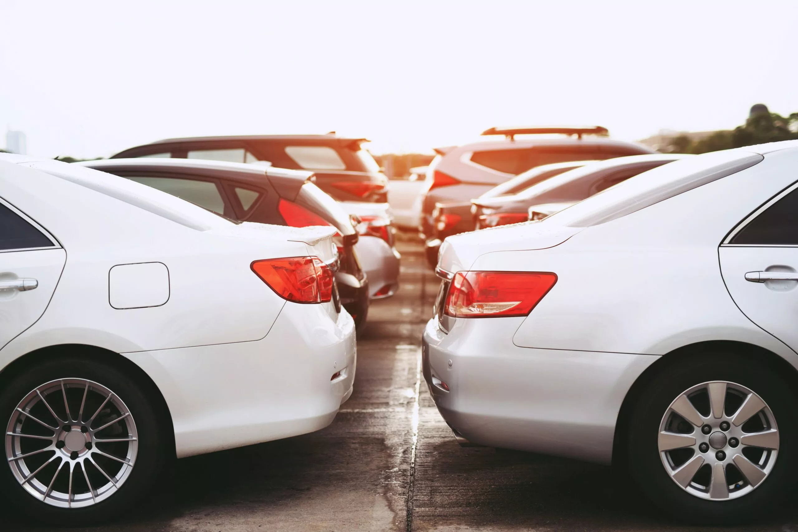 a row of parked cars in a parking lot