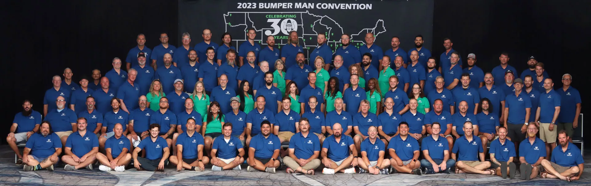 a large group of people standing in front of a stage